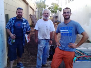 Chuck Weis (left), Jory Gessow of Gessow Landscaping (center), and Garden Educator Ezra Ranz (right) scope out the site for grading upgrades.